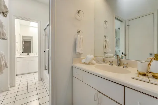 a en suite bathroom with a double vanity sink a mirror and a shower