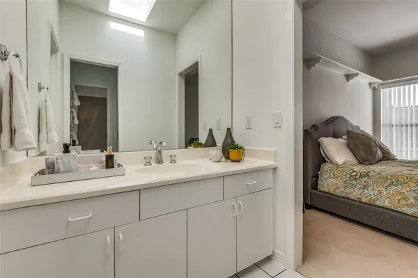 a en suite bathroom with a double vanity sink and a mirror