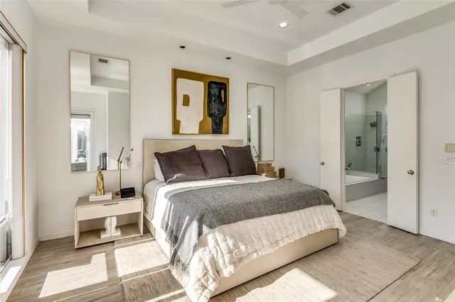 a bedroom with a bed and a mirror