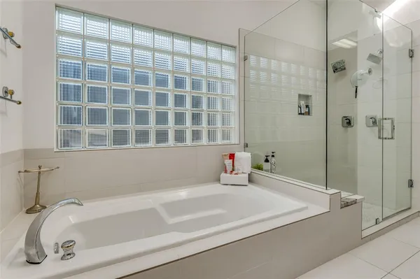 a bathroom with a bathtub and a shower