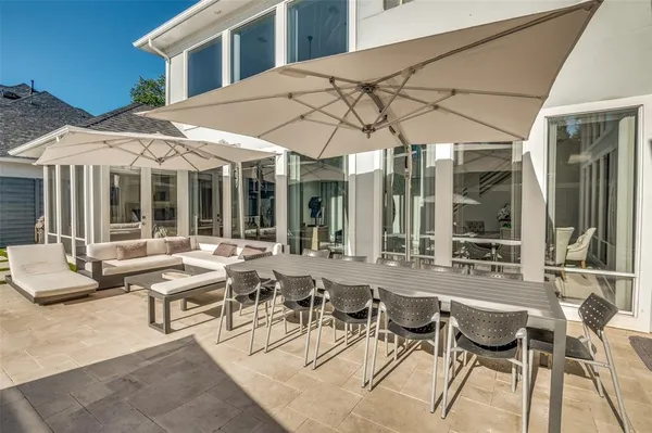 a view of a patio with table and chairs under an umbrella