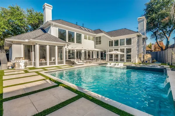 a view of a house with pool and chairs