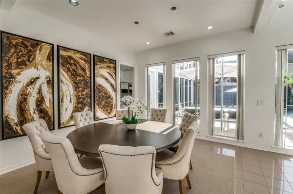 a dining room with furniture a large window and a rug
