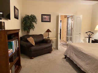1022 Selous Drive Murfreesboro, TN 37128 - Photo 19 of 29 a spacious bedroom with a bed a couch and a flat tv screen