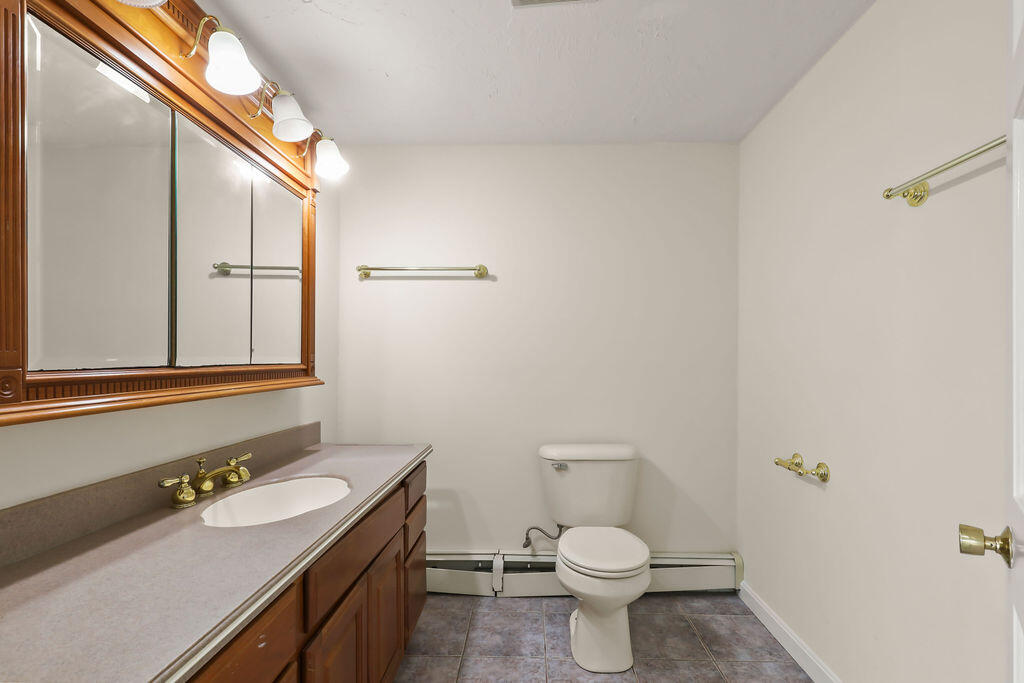 75 Edgewater Road Mashpee, MA 02649 - Photo 48 of 78 a bathroom with a toilet sink and mirror