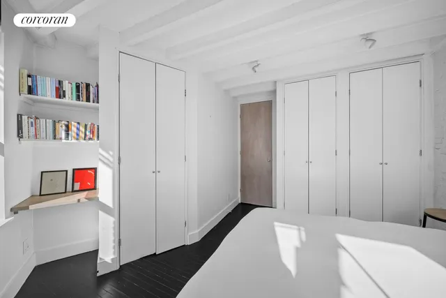 a room with bookshelf and a window