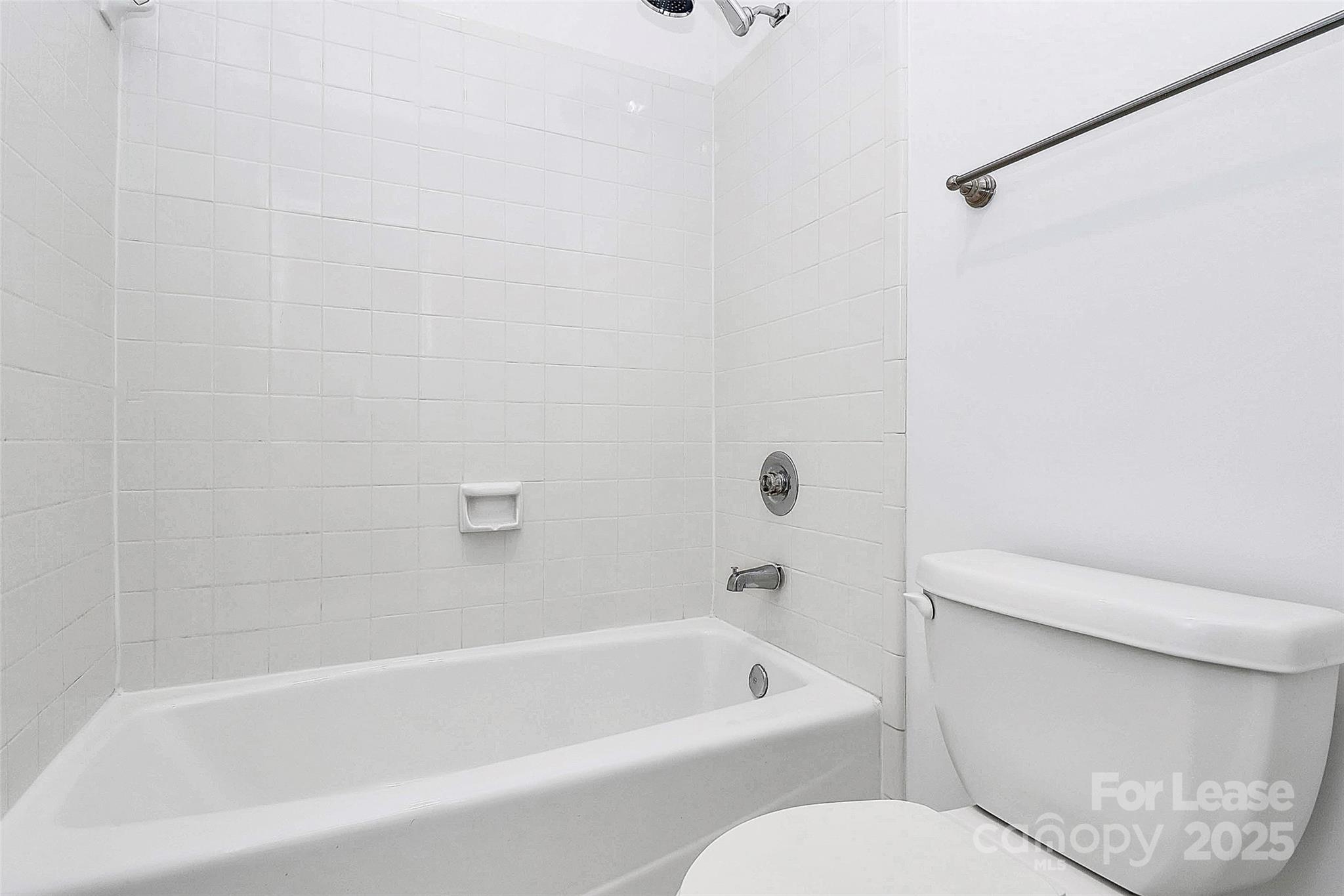 2220 Roswell Avenue, Unit A Charlotte, NC 28207 - Photo 11 of 34 a bathroom with a toilet and a bathtub