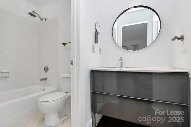 a bathroom with a toilet a sink and a mirror