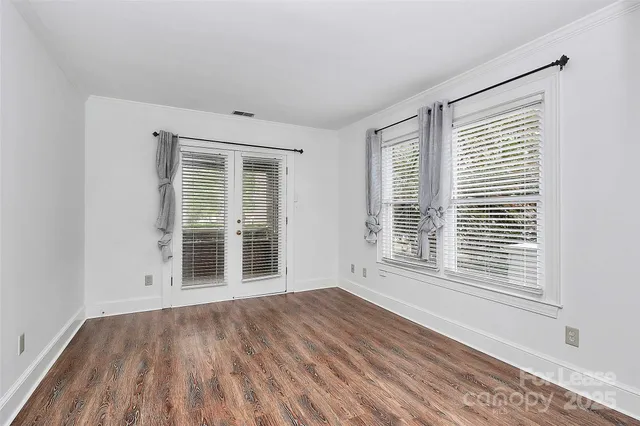 a view of wooden floor and windows in a room