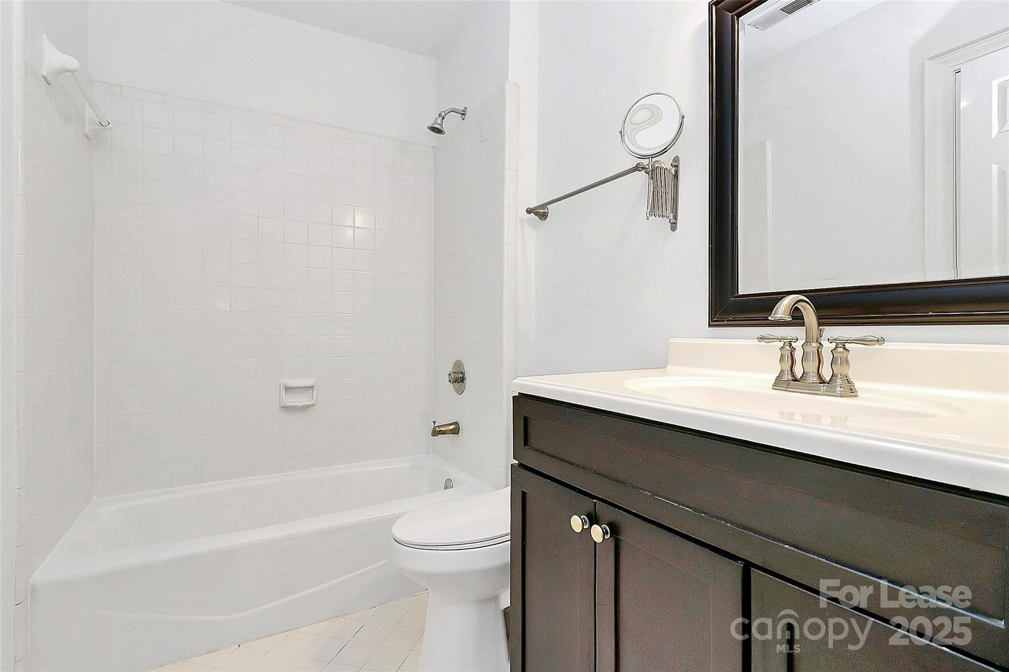 2220 Roswell Avenue, Unit A Charlotte, NC 28207 - Photo 14 of 34 a bathroom with a sink a toilet and shower
