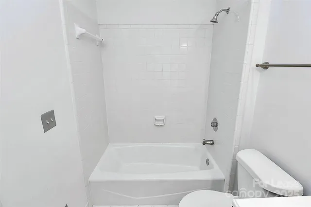 a bathroom with a bathtub and a toilet