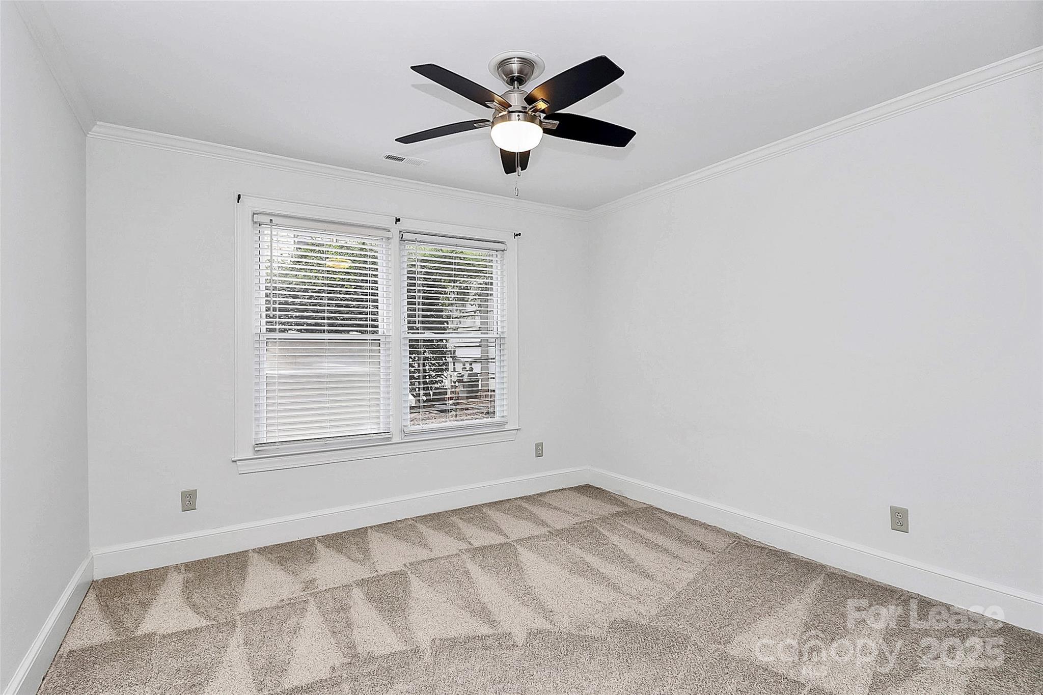 2220 Roswell Avenue, Unit A Charlotte, NC 28207 - Photo 16 of 34 an empty room with ceiling fan and window