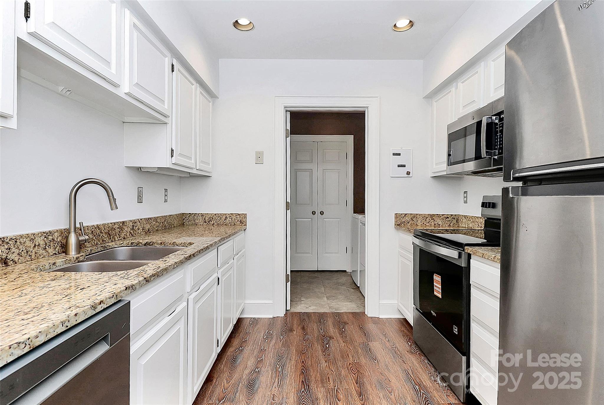 2220 Roswell Avenue, Unit A Charlotte, NC 28207 - Photo 19 of 34 a kitchen with stainless steel appliances granite countertop a sink stove and refrigerator