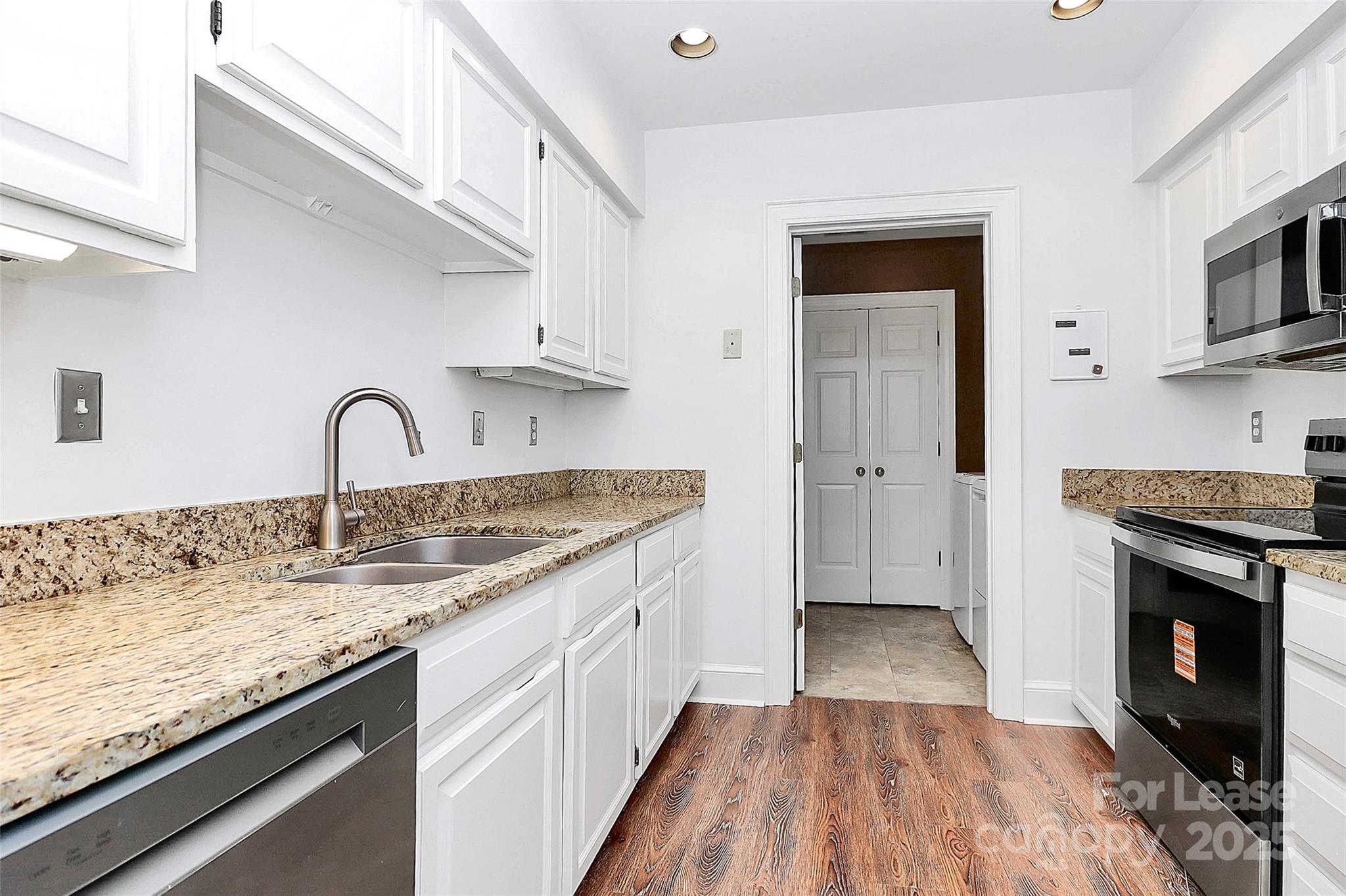 2220 Roswell Avenue, Unit A Charlotte, NC 28207 - Photo 20 of 34 a kitchen with granite countertop a sink stove and cabinets