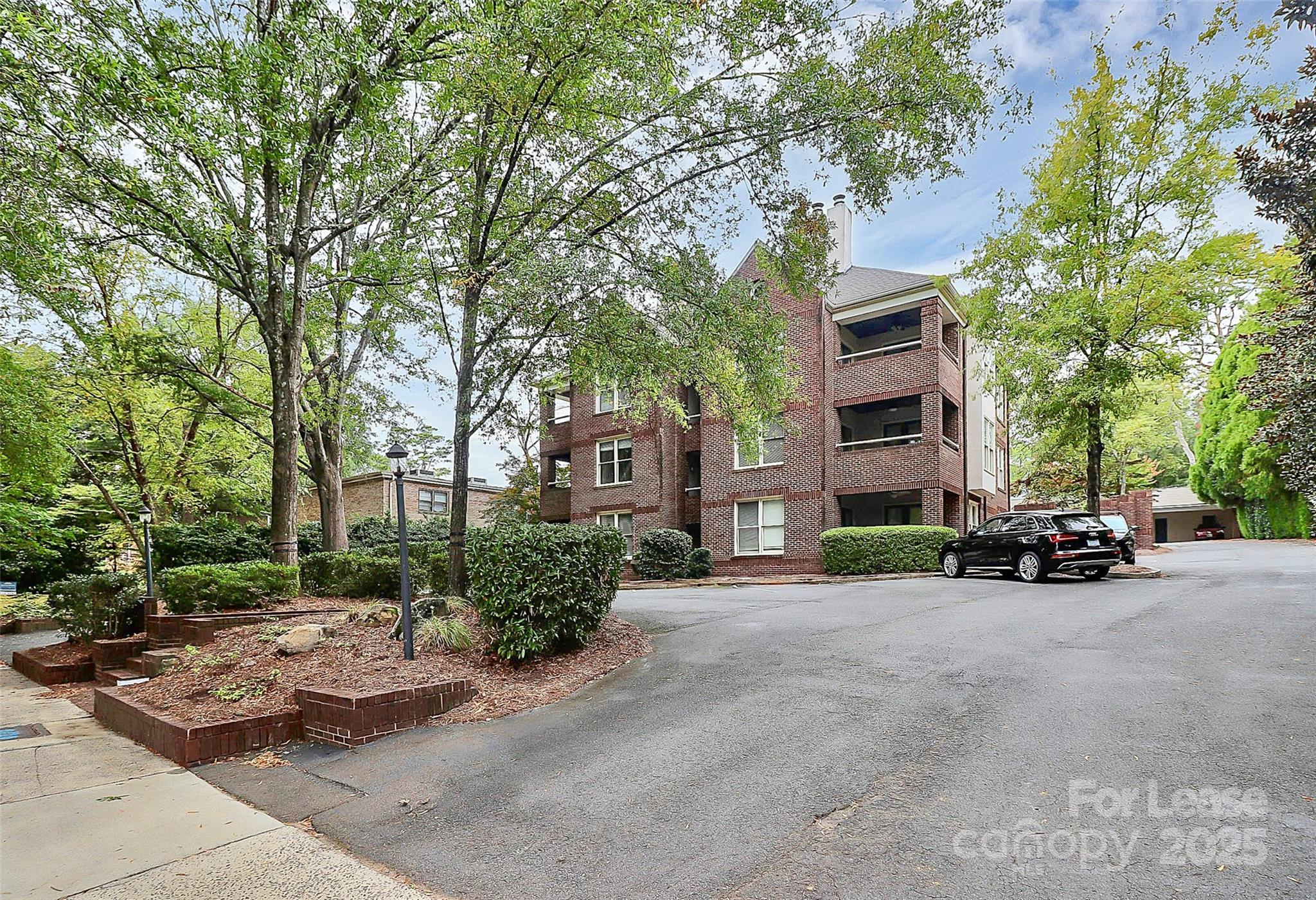2220 Roswell Avenue, Unit A Charlotte, NC 28207 - Photo 2 of 34 a view of a street with a bench and trees
