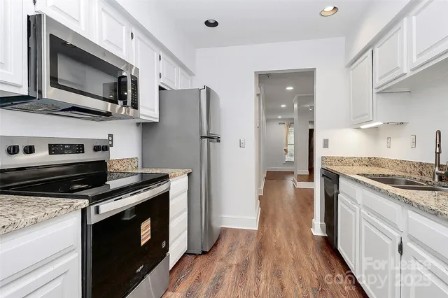 a kitchen with stainless steel appliances a stove microwave and refrigerator
