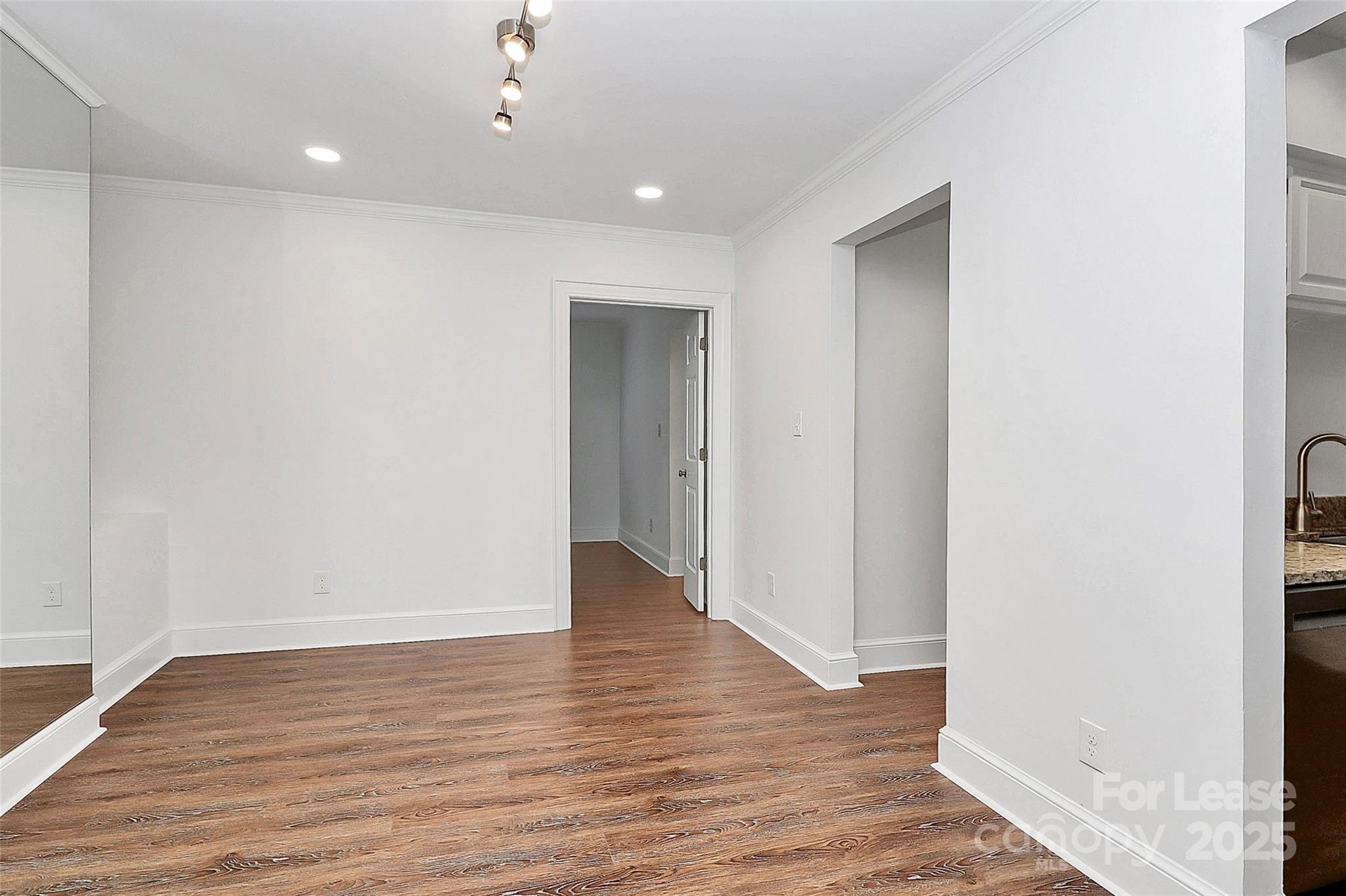 2220 Roswell Avenue, Unit A Charlotte, NC 28207 - Photo 27 of 34 a view of an empty room with wooden floor