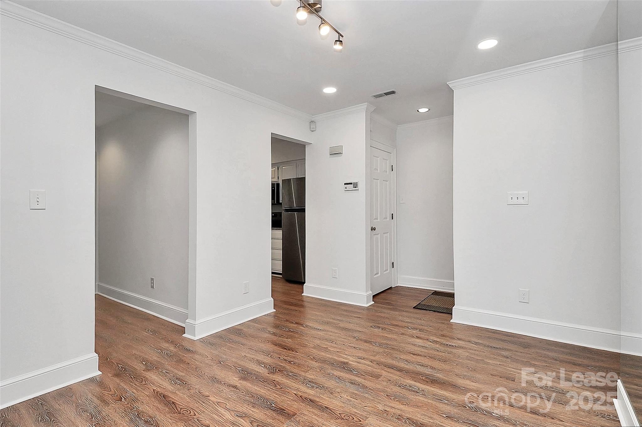 2220 Roswell Avenue, Unit A Charlotte, NC 28207 - Photo 29 of 34 an empty room with wooden floor and windows