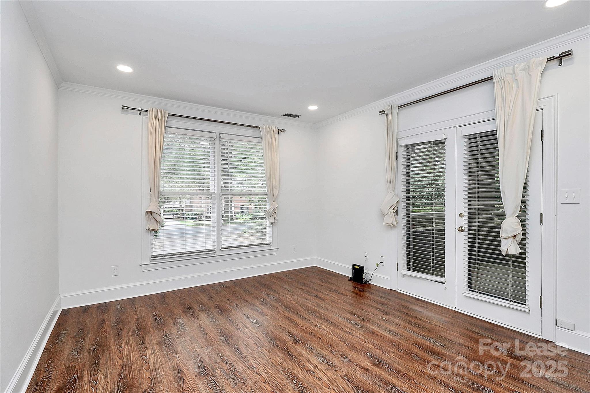 2220 Roswell Avenue, Unit A Charlotte, NC 28207 - Photo 30 of 34 a view of empty room with wooden floor and fan