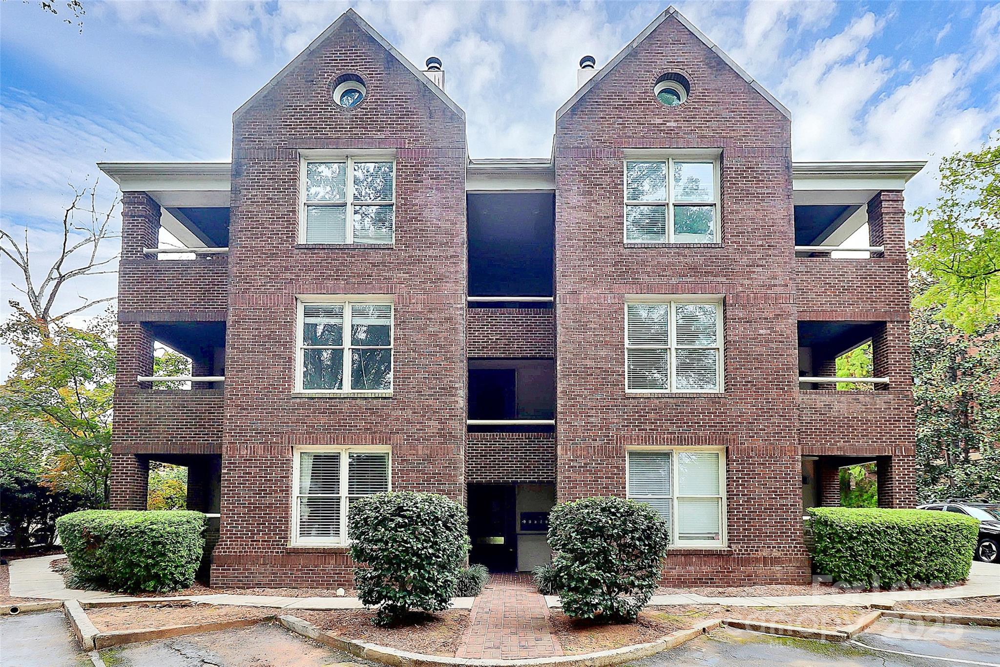2220 Roswell Avenue, Unit A Charlotte, NC 28207 - Photo 4 of 34 front view of a brick house with a yard