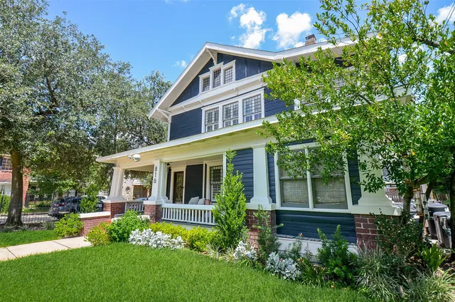 a front view of a house with a yard table and chairs