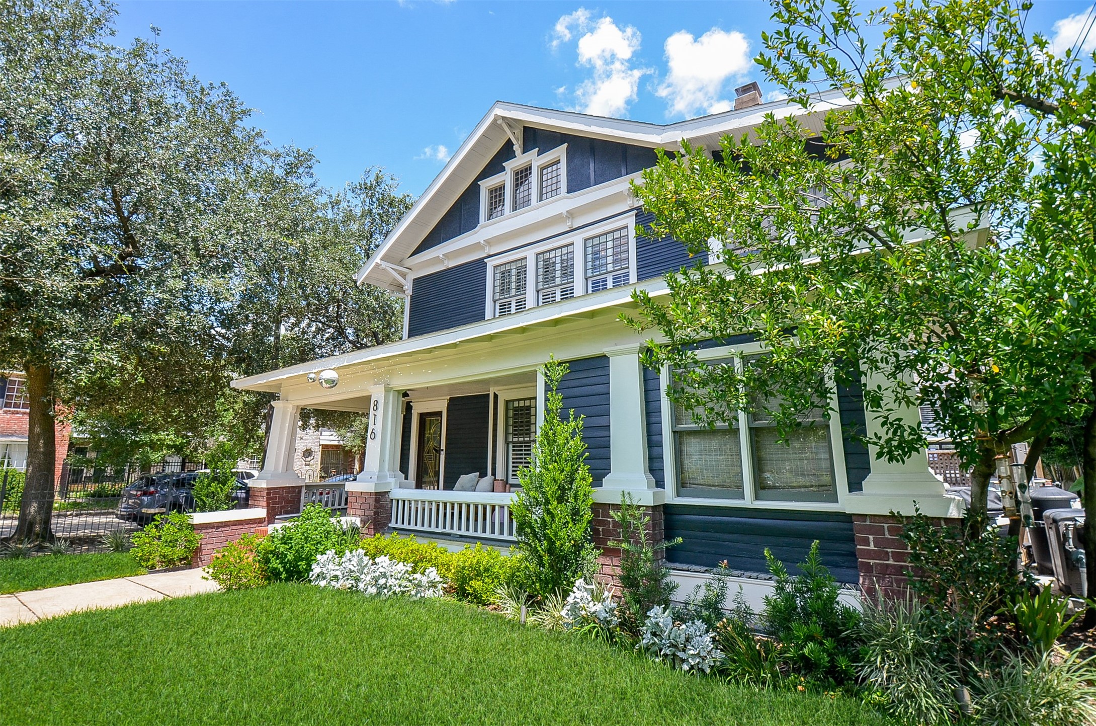 a front view of a house with a yard table and chairs