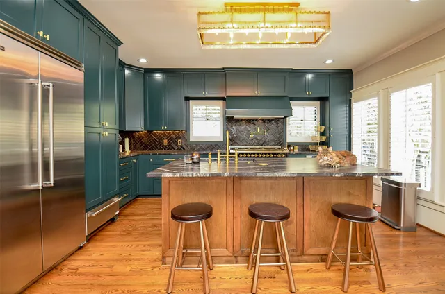 a kitchen with cabinets and chairs