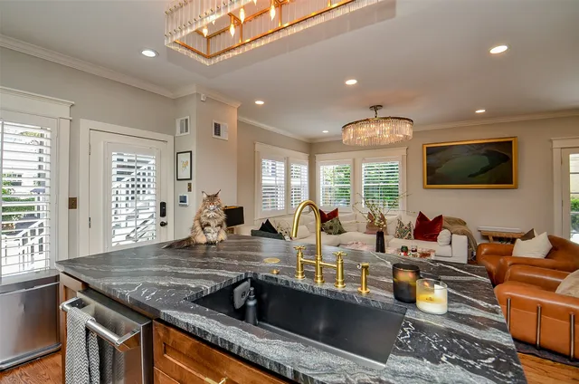 a living room with kitchen island furniture and a flat screen tv