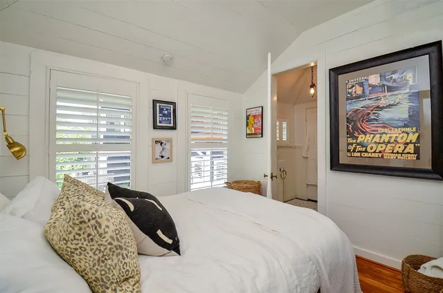 a bedroom with a bed and a painting on the wall