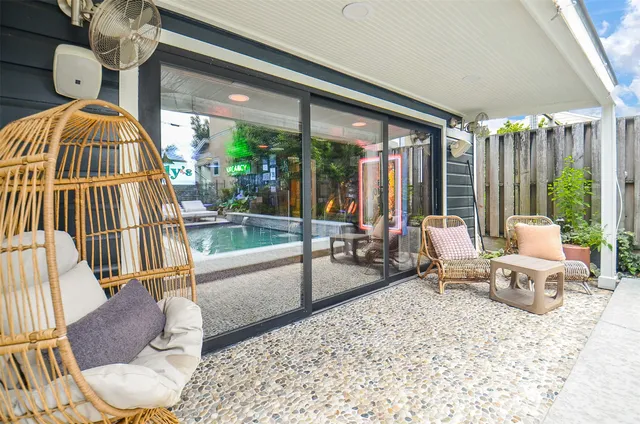 a living room with furniture and large windows