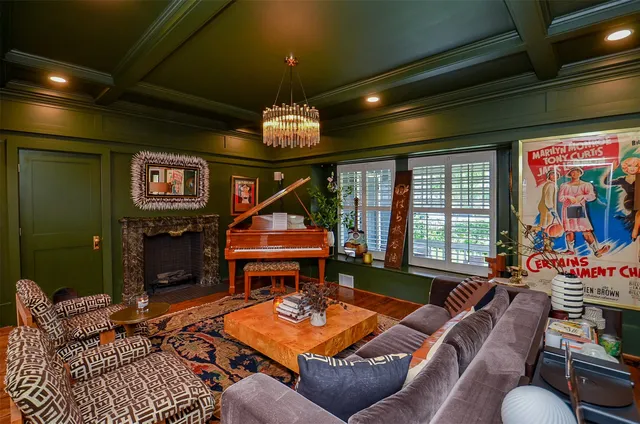 a living room with furniture a window and a chandelier