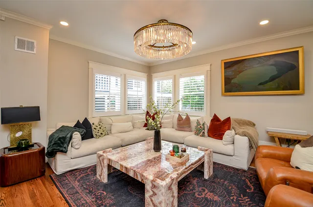 a living room with furniture a large window and a table