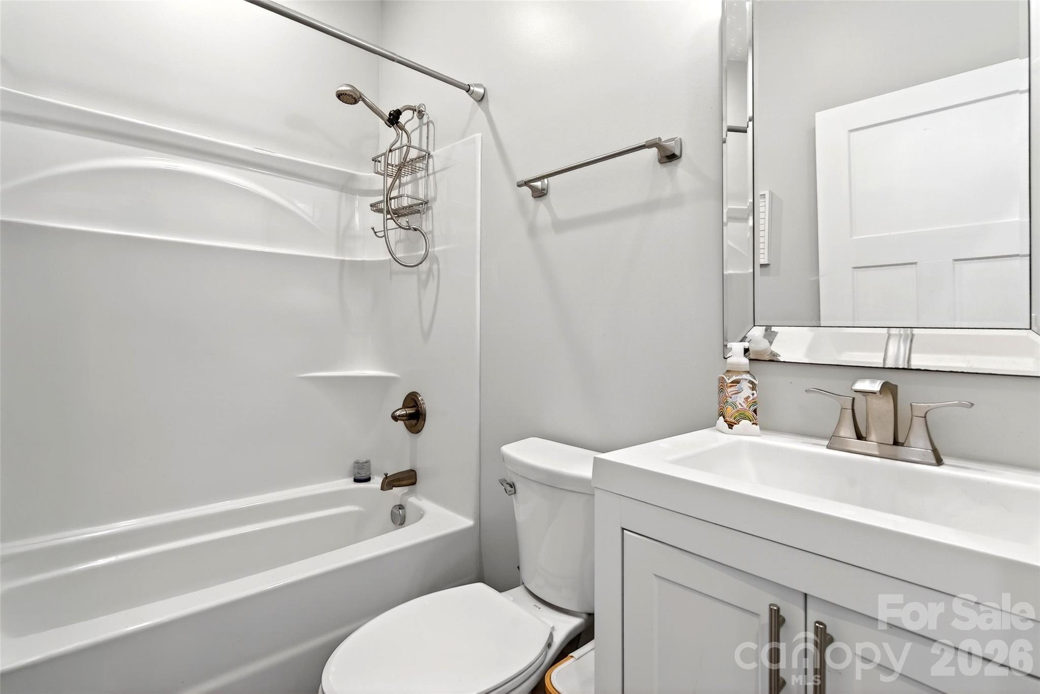 135 Ridge Road Candler, NC 28715 - Photo 20 of 40 a bathroom with a sink a toilet and a bathtub