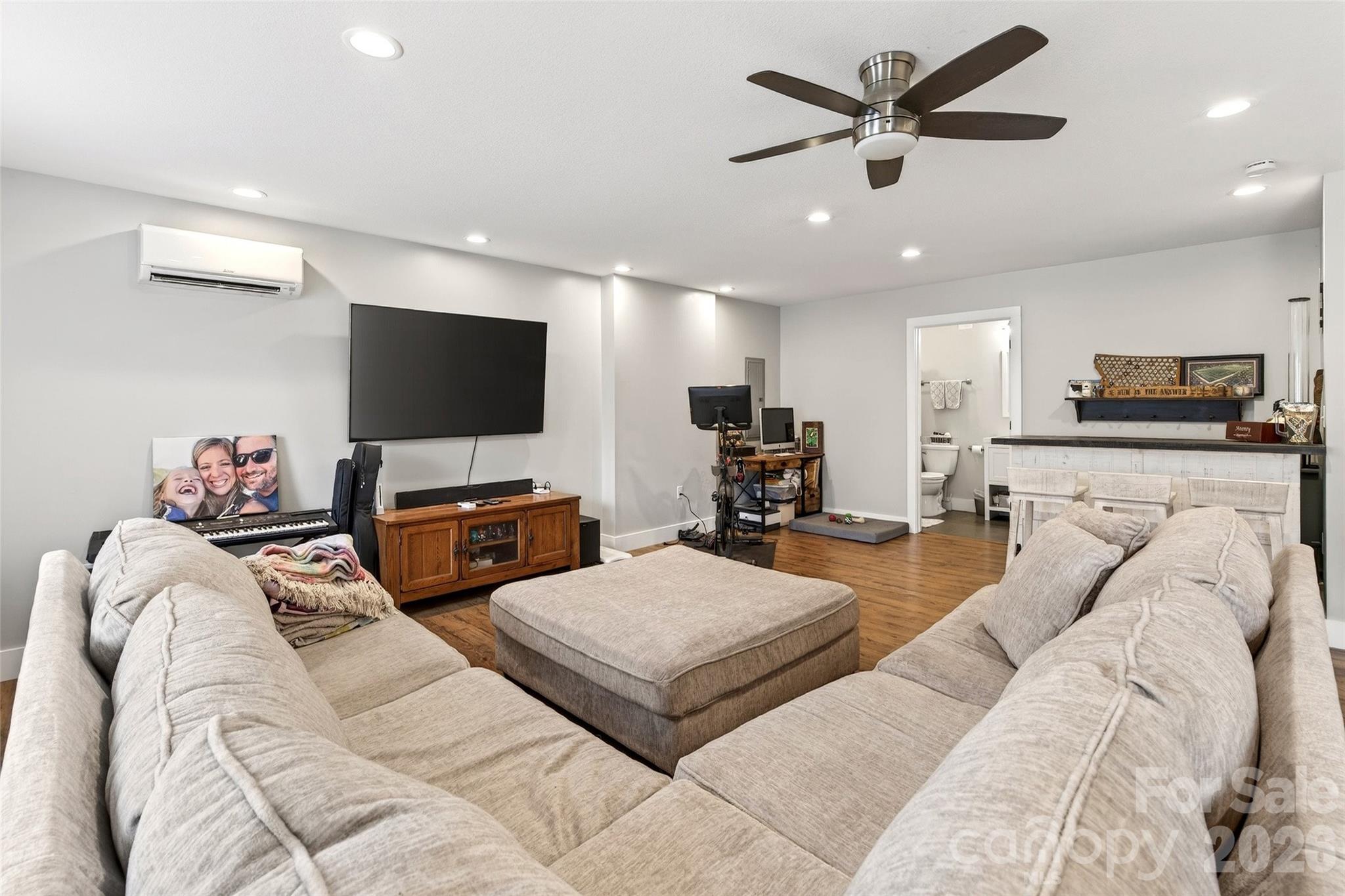 135 Ridge Road Candler, NC 28715 - Photo 26 of 40 a living room with furniture and a flat screen tv