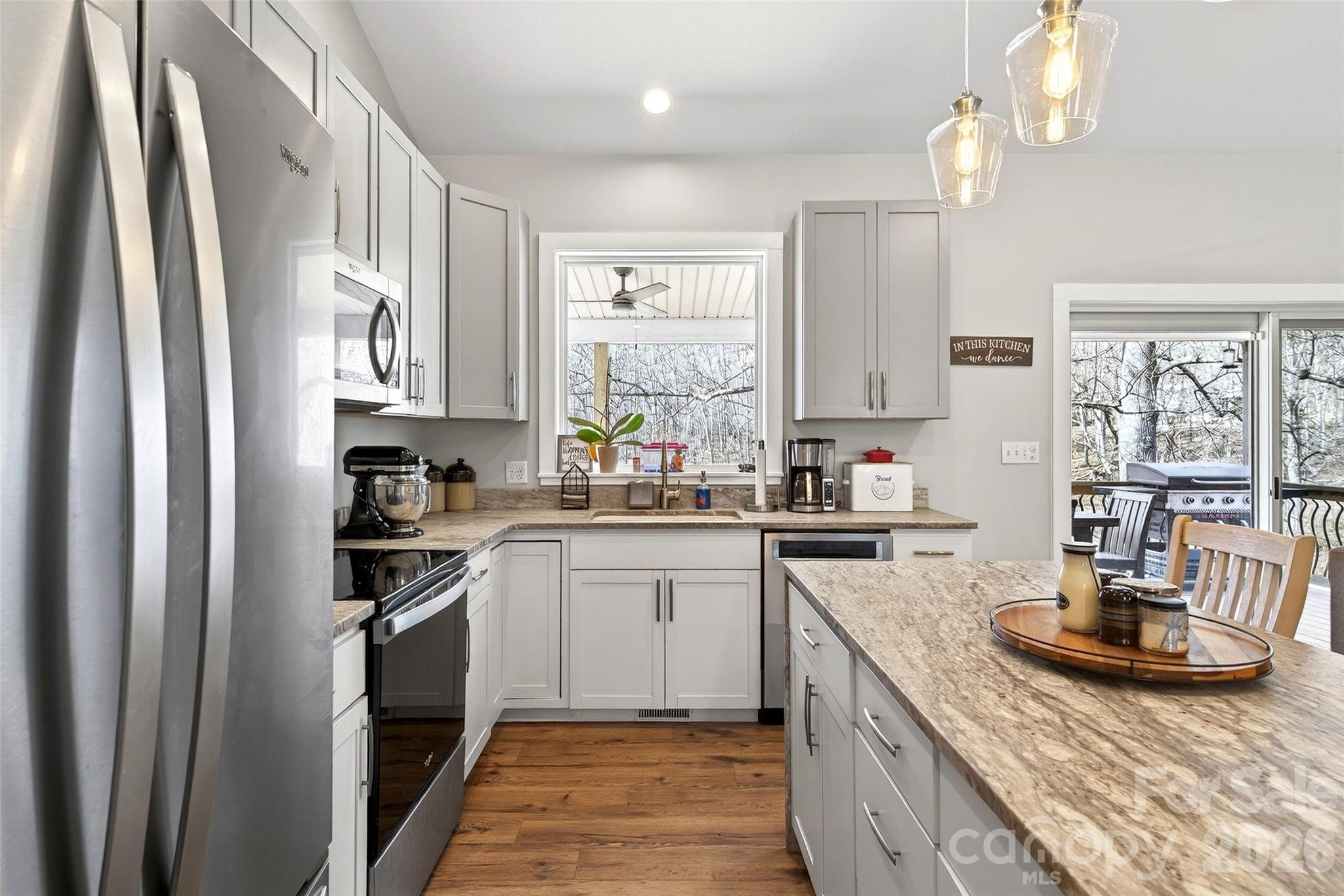 135 Ridge Road Candler, NC 28715 - Photo 7 of 40 a kitchen with stainless steel appliances granite countertop a sink stove and refrigerator