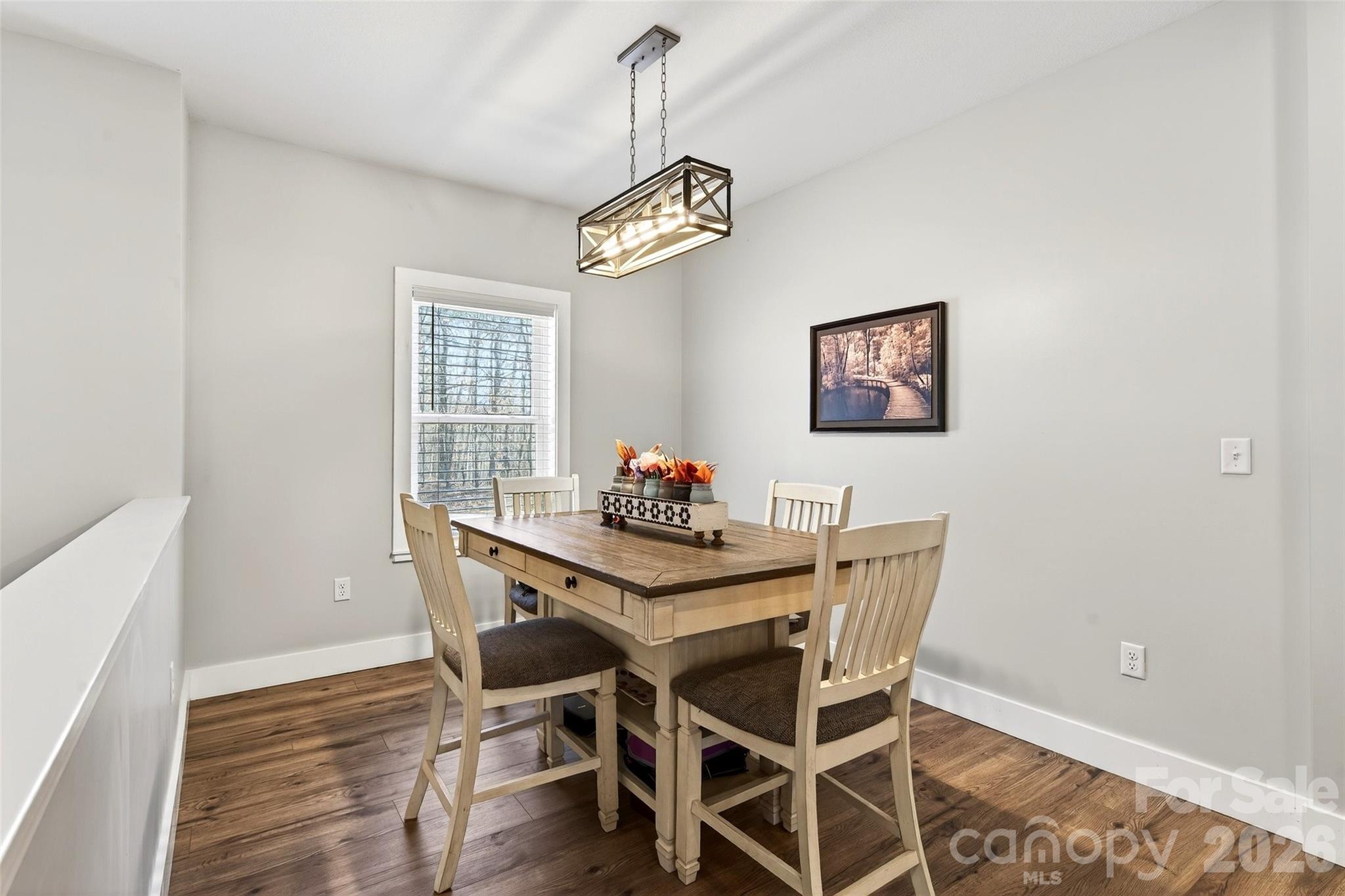 135 Ridge Road Candler, NC 28715 - Photo 9 of 40 a view of a dining room with furniture wooden floor and a chandelier
