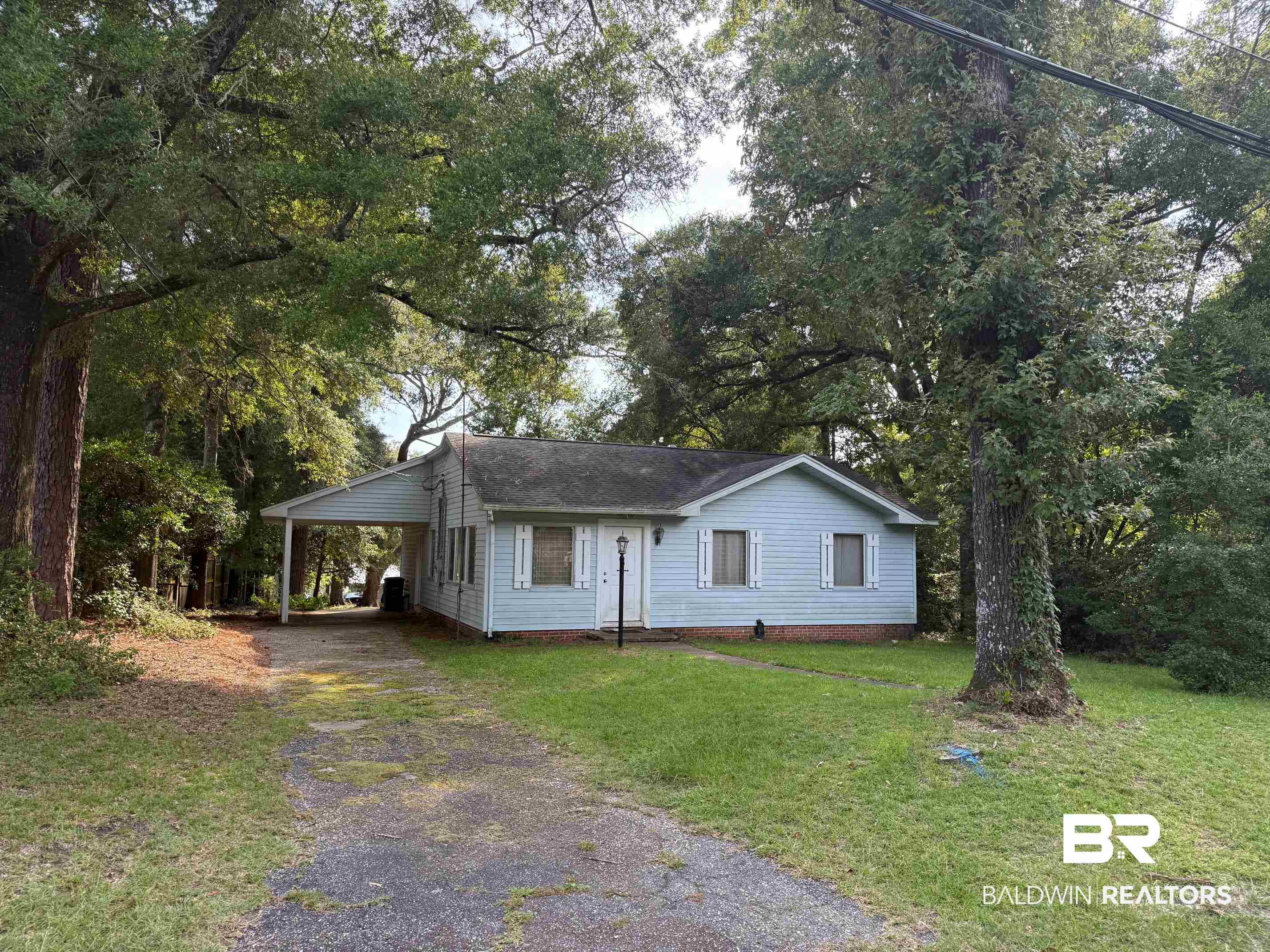 156 Pier Avenue Fairhope, AL 36532 - Photo 3 of 41 View of front facade with driveway, a carport, and a front lawn