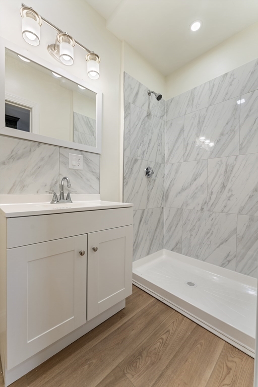 27 Perrin Street, Unit 1 Boston, MA 02119 - Photo 15 of 22 a bathroom with a sink vanity granite tub shower and a mirror