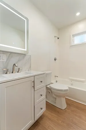 a bathroom with a toilet sink and mirror