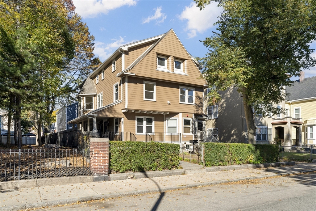 27 Perrin Street, Unit 1 Boston, MA 02119 - Photo 2 of 22 a front view of a house with a garden and tree