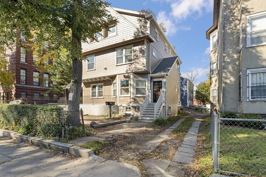 27 Perrin Street, Unit 1 Boston, MA 02119 - Photo 22 of 22 a front view of a house with a yard