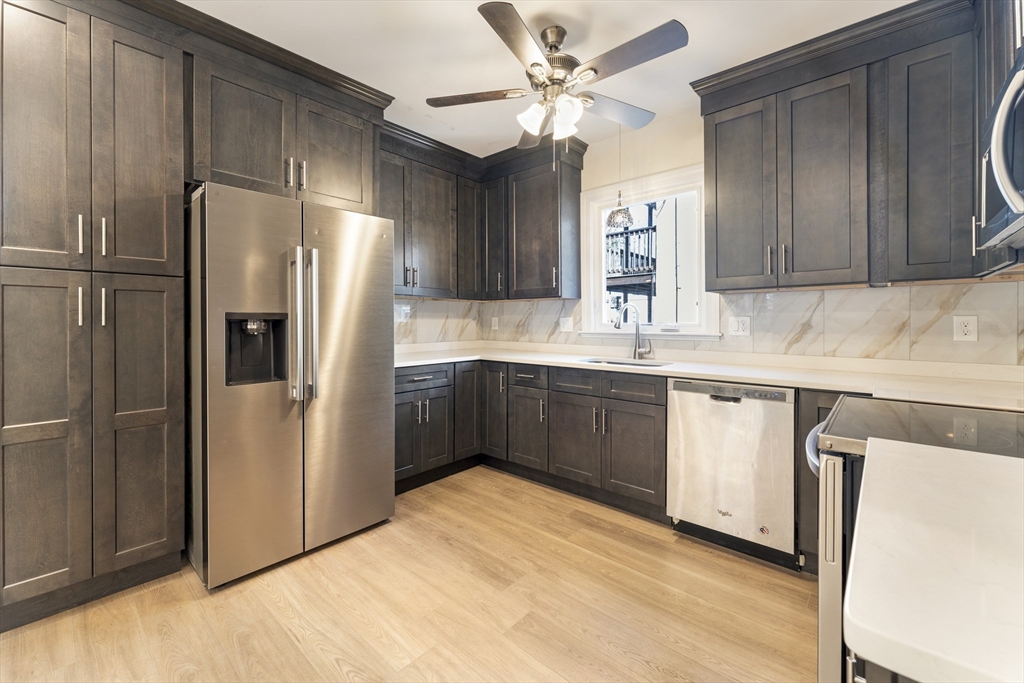 27 Perrin Street, Unit 1 Boston, MA 02119 - Photo 5 of 22 a kitchen with stainless steel appliances a refrigerator sink and cabinets