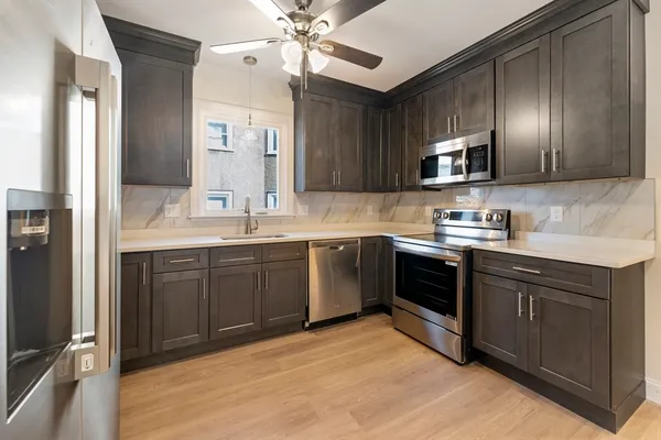 a kitchen with a sink cabinets and stainless steel appliances
