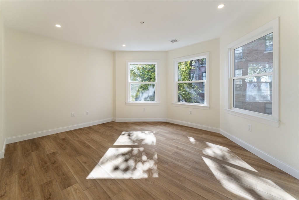 27 Perrin Street, Unit 1 Boston, MA 02119 - Photo 8 of 22 a view of an empty room with wooden floor and a window