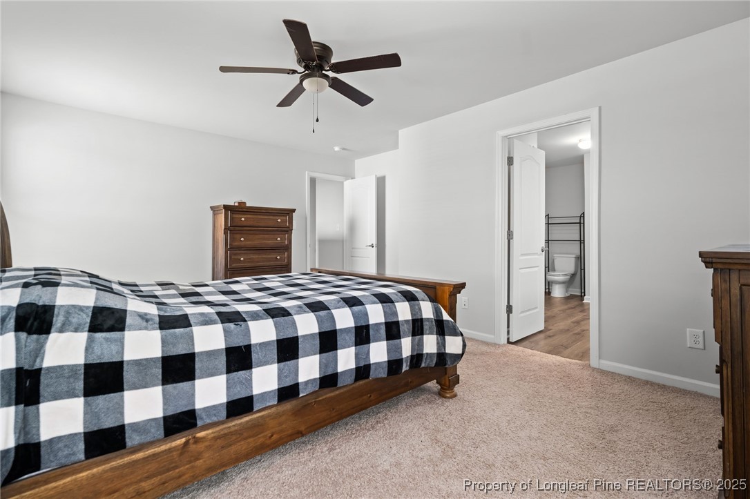 5926 Lowgrass Road Stedman, NC 28391 - Photo 21 of 39 a bedroom with a bed and a black mirror