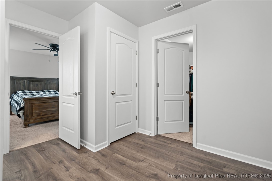 5926 Lowgrass Road Stedman, NC 28391 - Photo 24 of 39 a view of an empty room with wooden floor and a cabinet