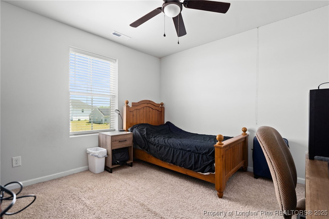 5926 Lowgrass Road Stedman, NC 28391 - Photo 25 of 39 a living room with furniture a ceiling fan and a window