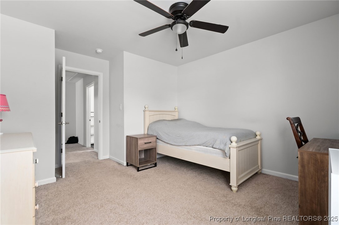 5926 Lowgrass Road Stedman, NC 28391 - Photo 29 of 39 a bedroom with a bed and a chandelier