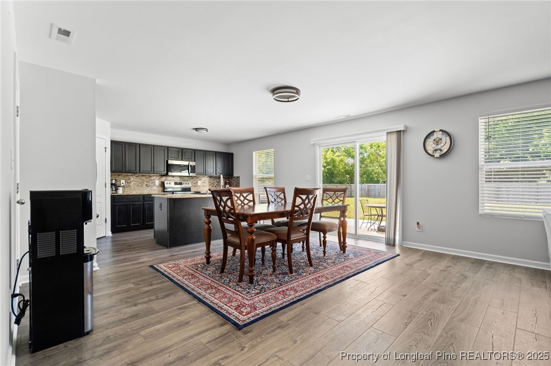5926 Lowgrass Road Stedman, NC 28391 - Photo 10 of 39 a dining room with furniture and wooden floor