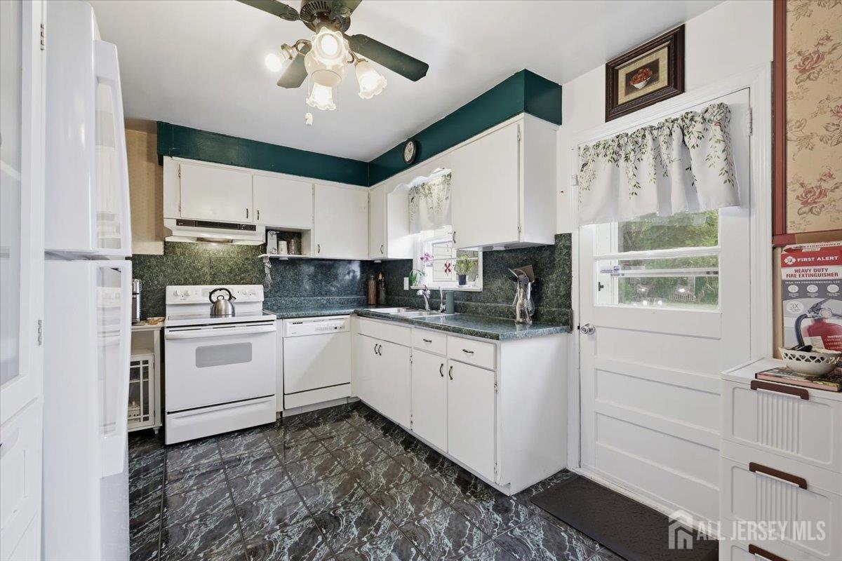 33 Ellison Road Somerset, NJ 08873 - Photo 8 of 38 a kitchen with granite countertop white cabinets and white appliances